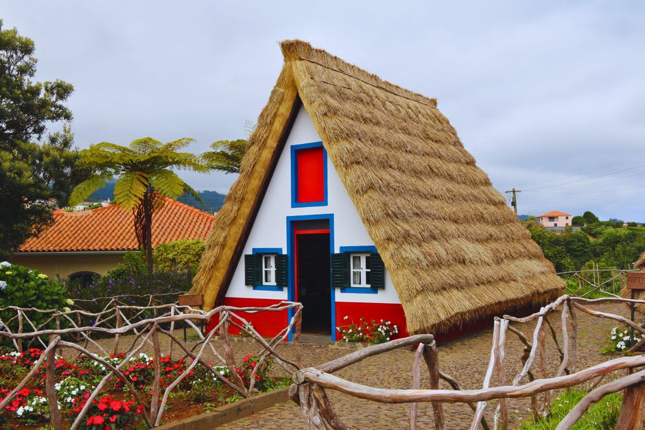 Interior of a traditional palheiro thatched house in Santana showing its low, steeply pitched roof