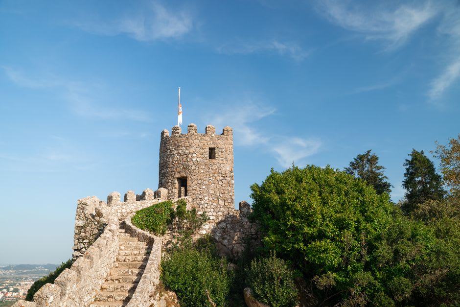 View from Sesimbra's Moorish castle walls down over the whitewashed town and the curve of the bay