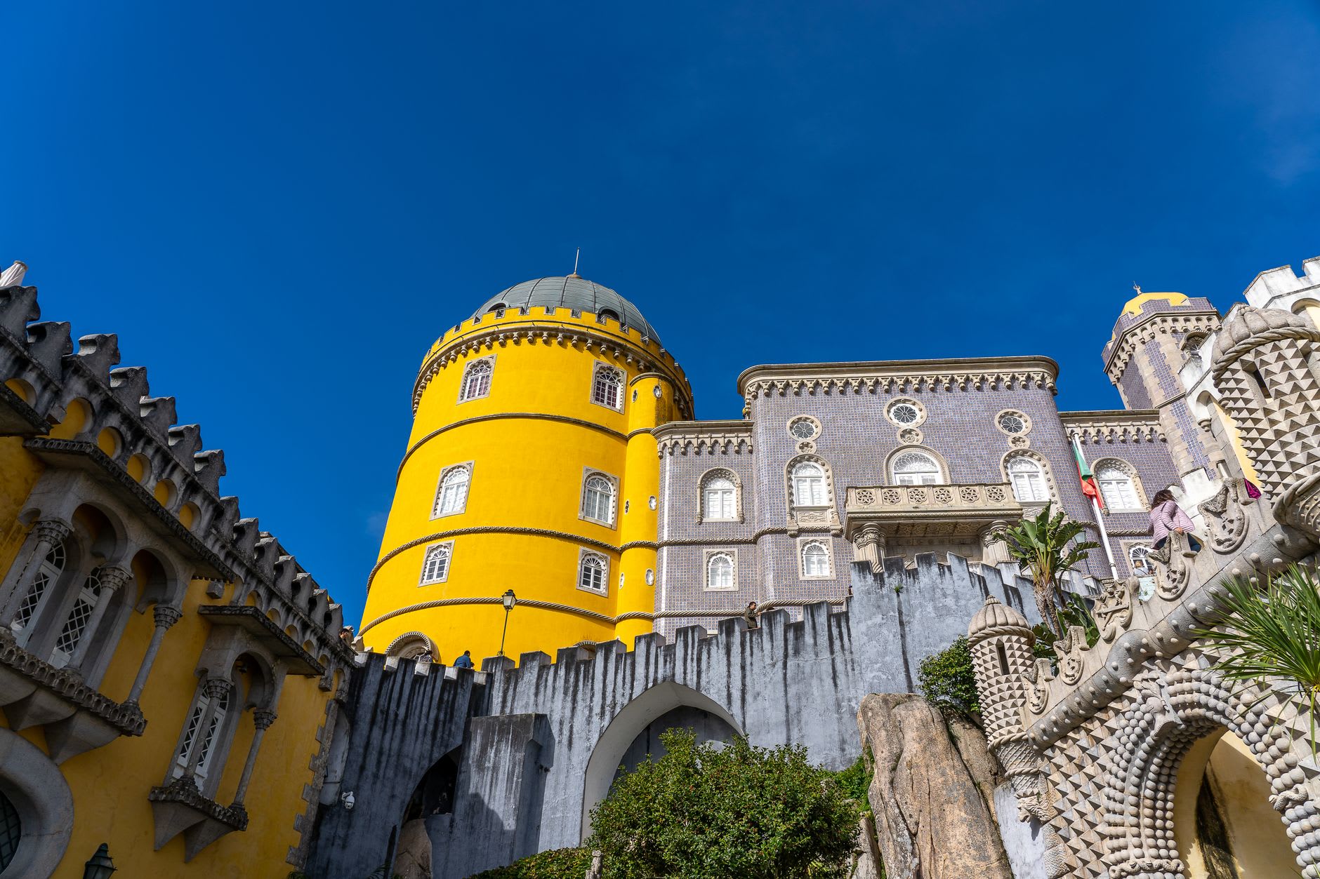 Pena Palace colorful towers and battlements rising above Sintra forest