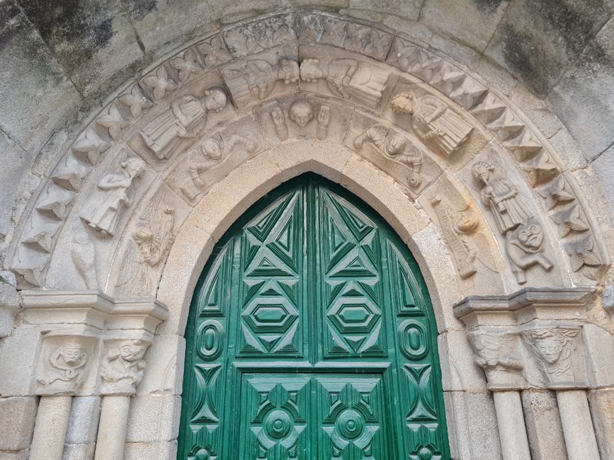 Carved stone doorframe in Trancoso's old Jewish quarter with a faint symbol above the lintel
