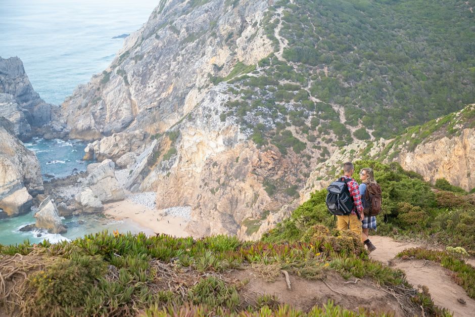 Steep cliffside path leading down to the wide Atlantic beach at Zambujeira do Mar