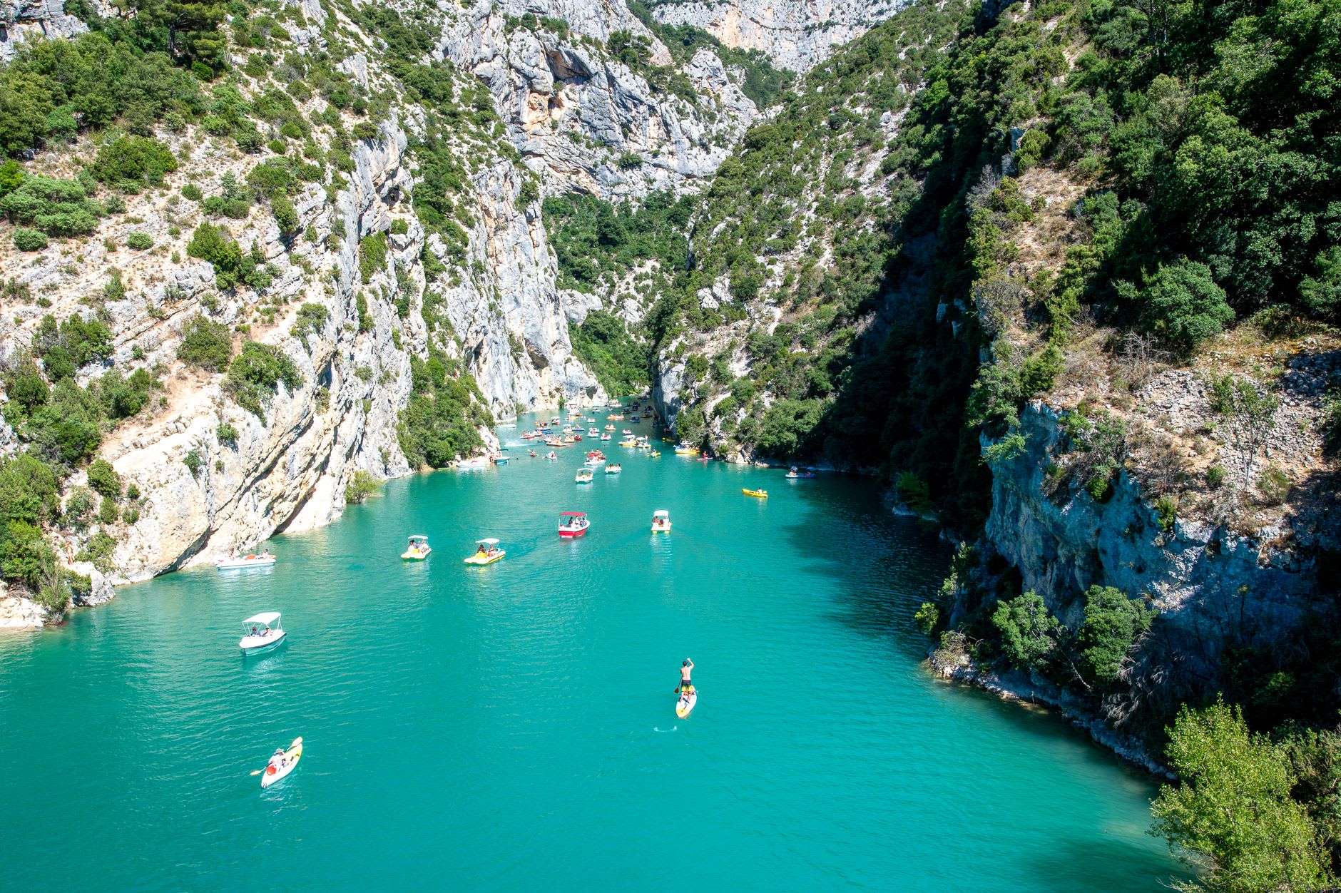 Kayaks on the turquoise water at the mouth of the Verdon gorge below towering cliffs