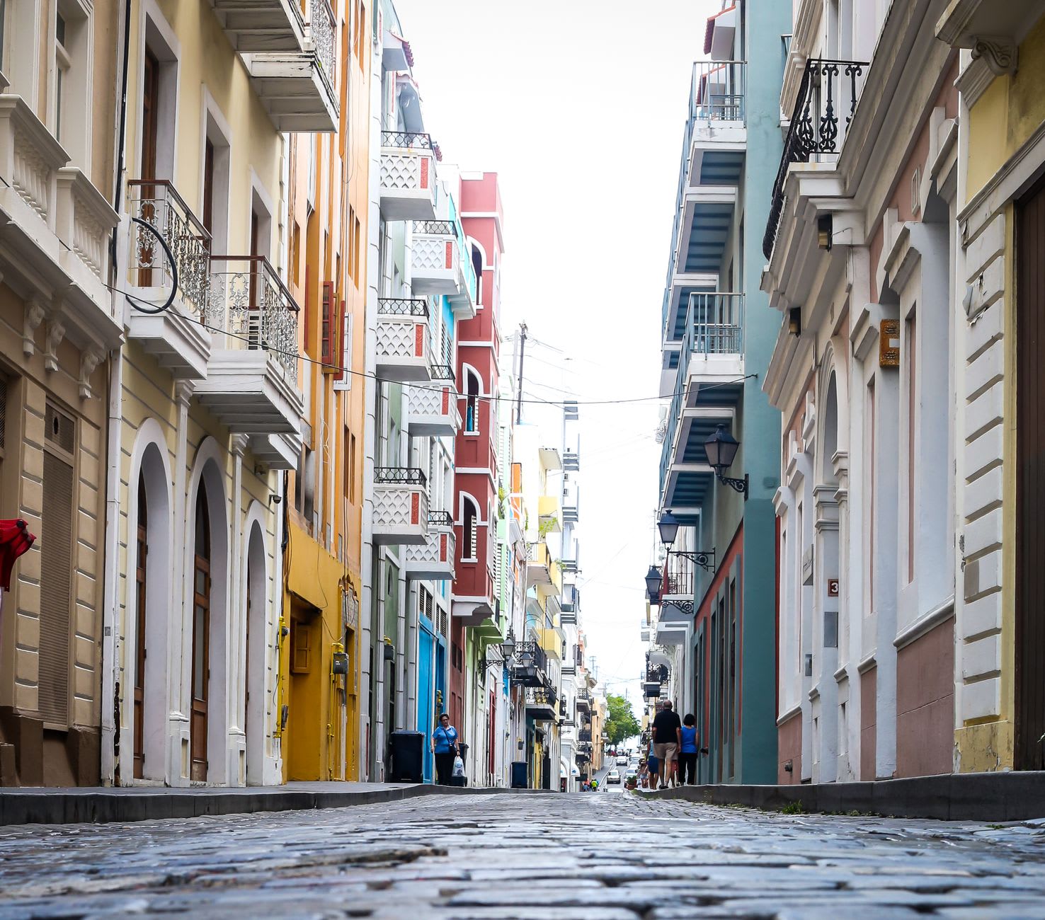 Cobblestone street lined with colorful painted buildings in Old San Juan at sunset