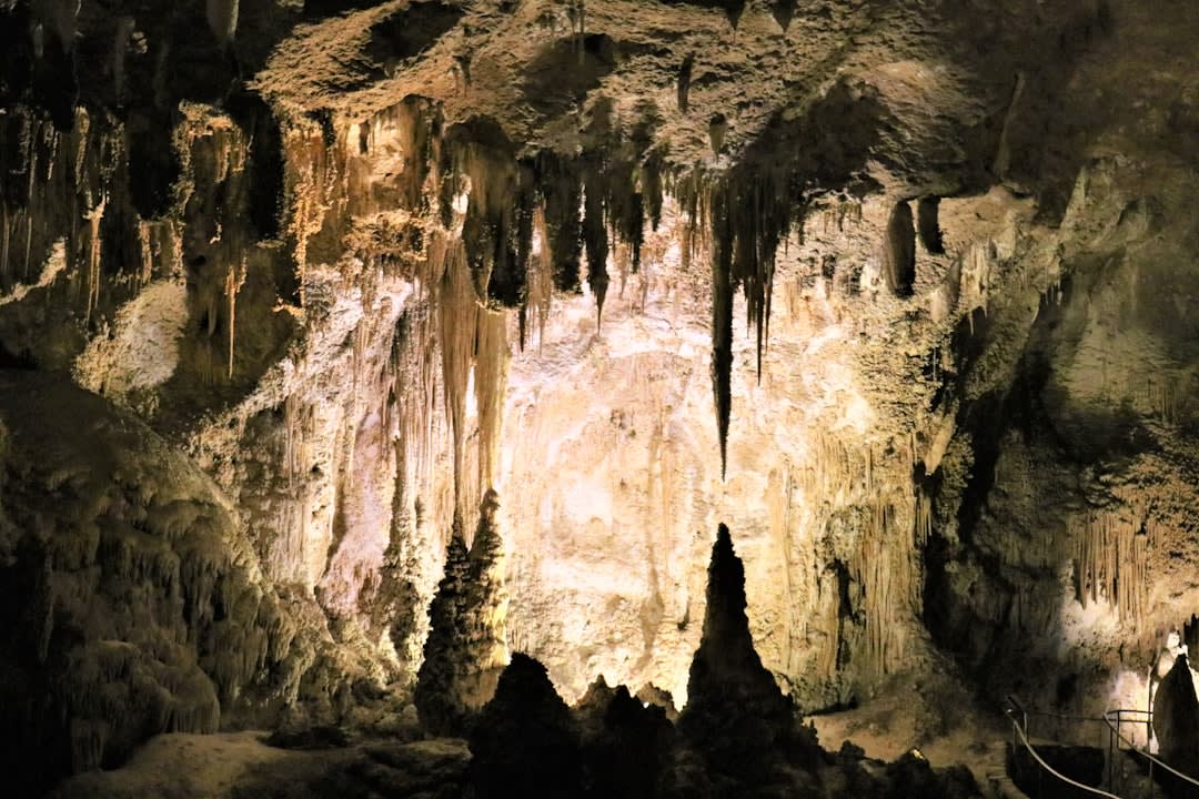 Towering stalactite and stalagmite formations inside Cueva Clara chamber