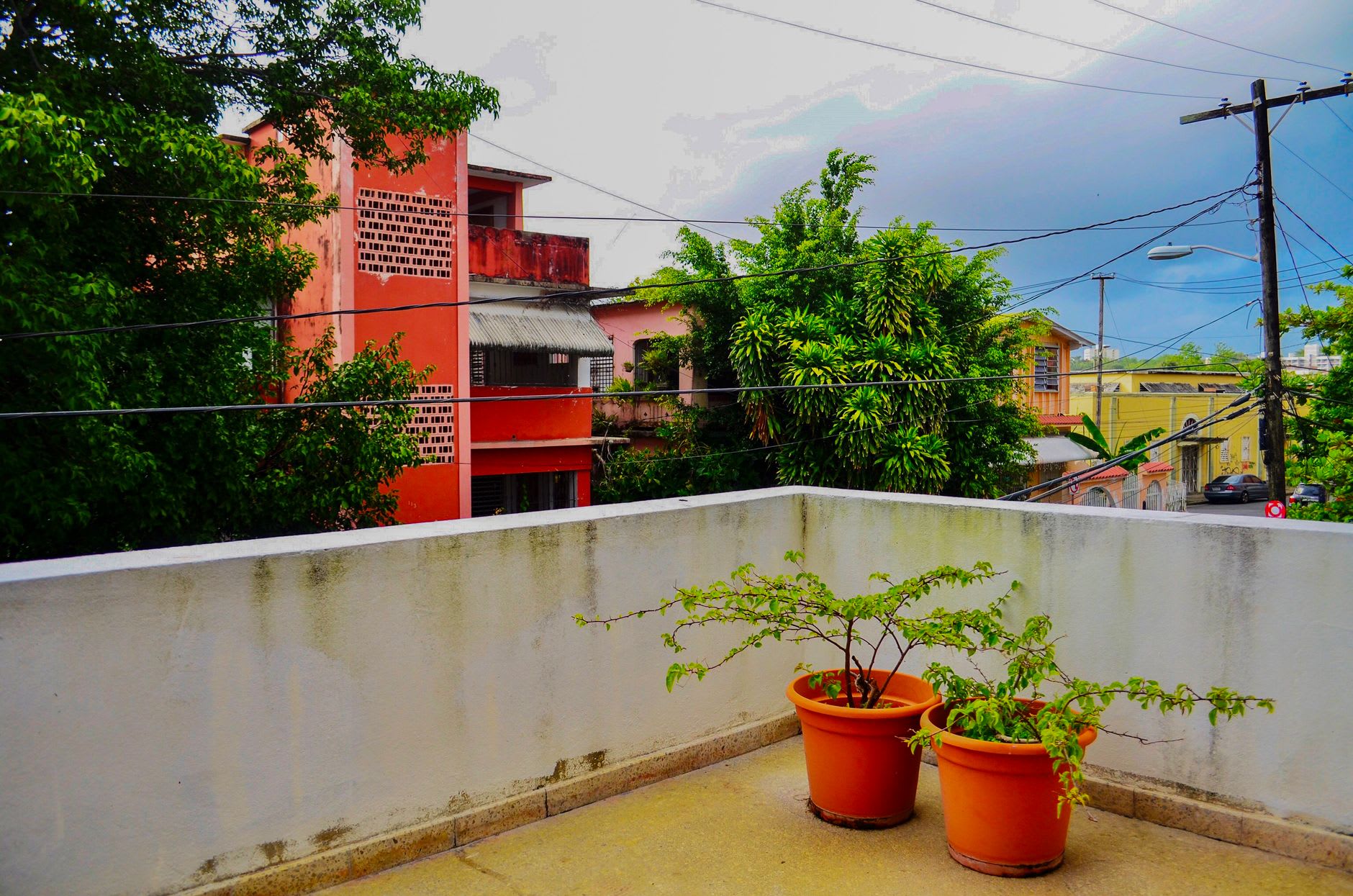 A pastel colonial street of San Germán lined with wooden balconies and shuttered windows