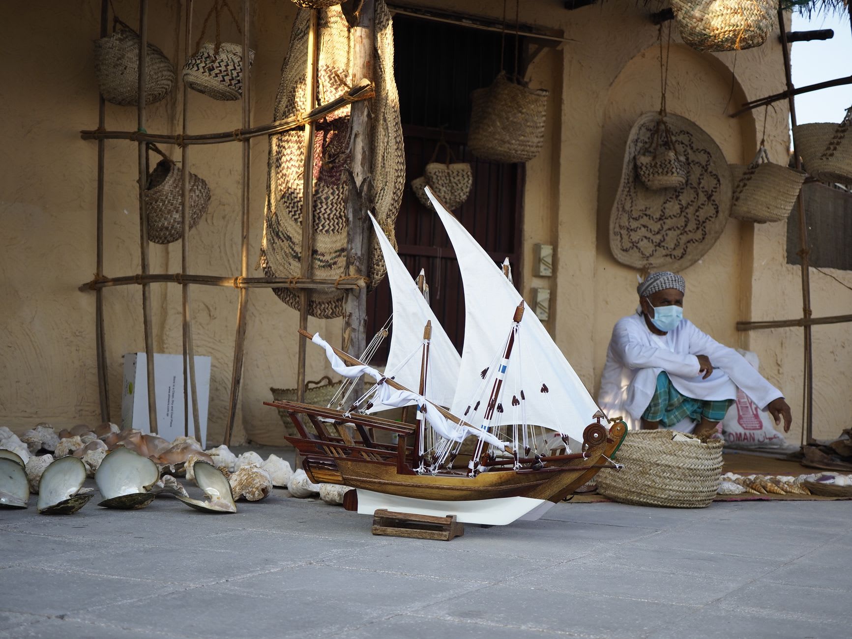 A bowl of harees with clarified butter pooling on top, served at an outdoor table at Souq Waqif