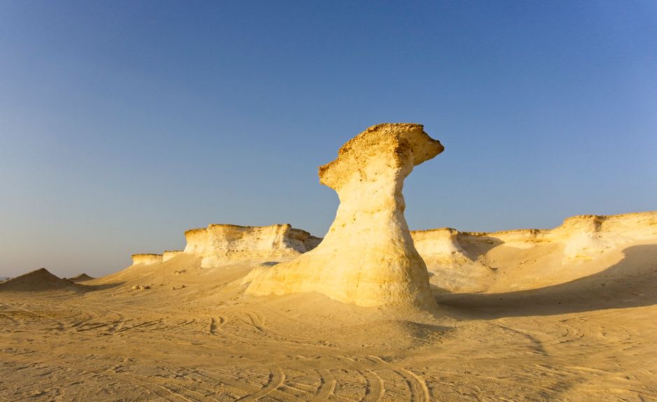 The mushroom-shaped limestone rock formations of Ras Abrouq glowing in late afternoon light