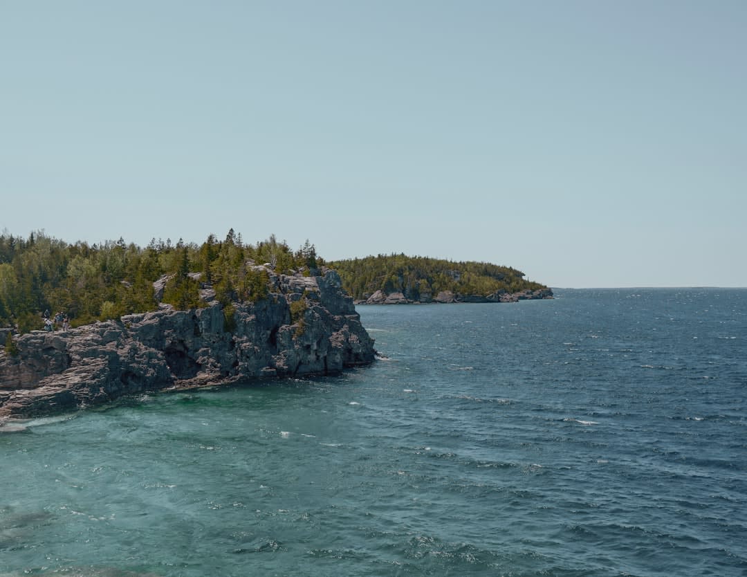 Freshwater lake surrounded by limestone cliffs with ancient rock paintings, Mansuar Island