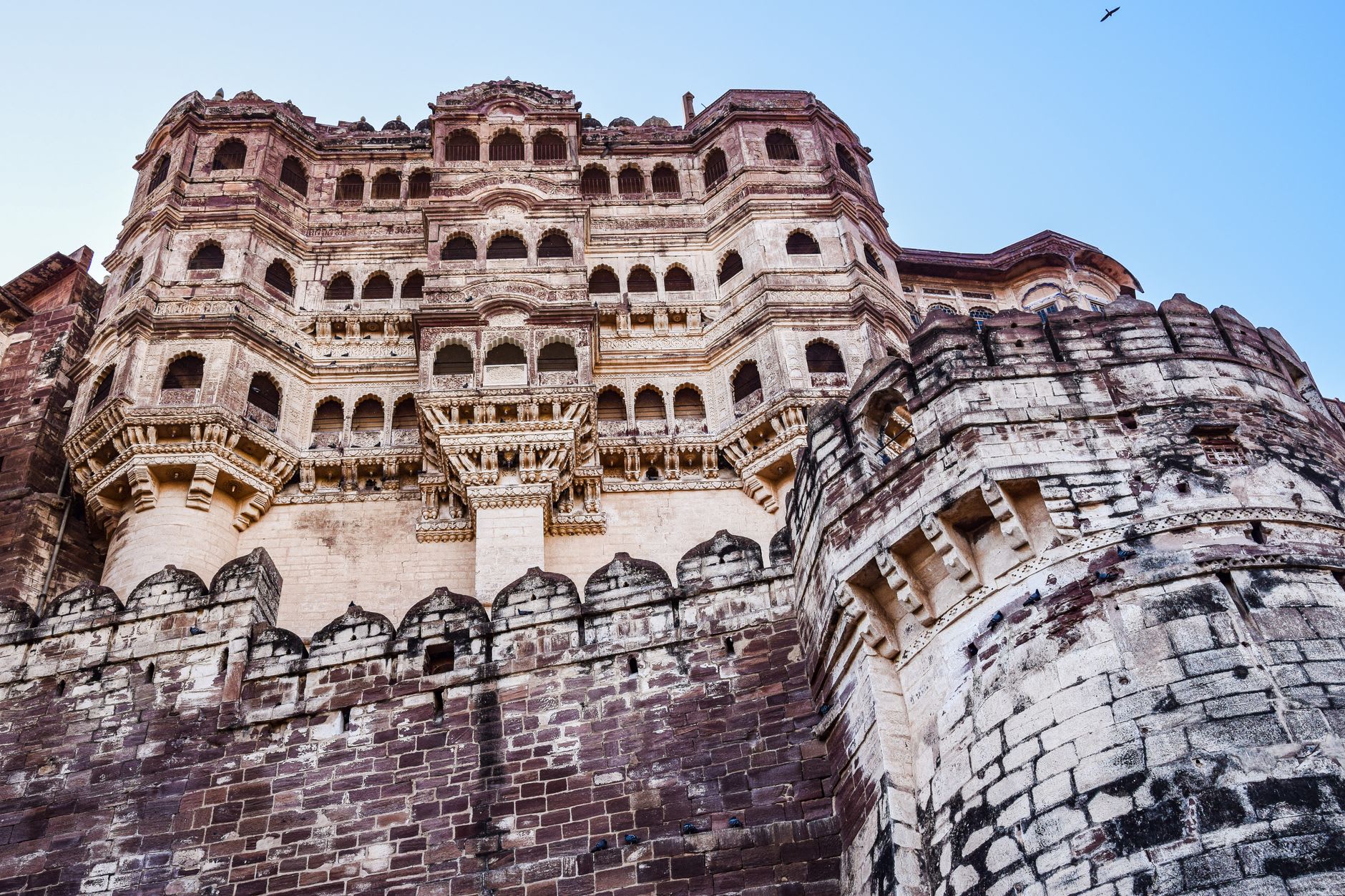 Mehrangarh Fort's massive stone gate with visible cannonball impact marks from the 1807 Jaipur army attack