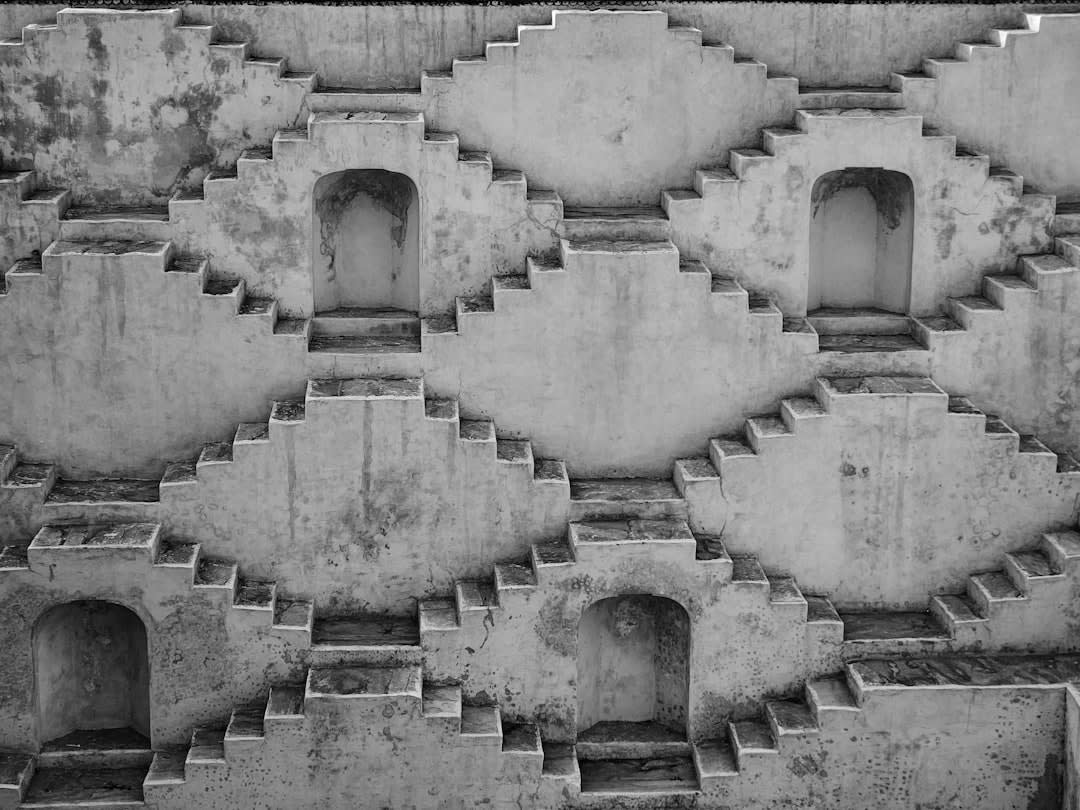 A quiet stone stepwell inside Kumbhalgarh Fort's grounds, shaded from the midday sun