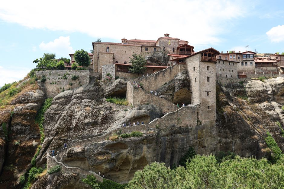 Monks tending vegetable gardens on the slope below the monastery walls