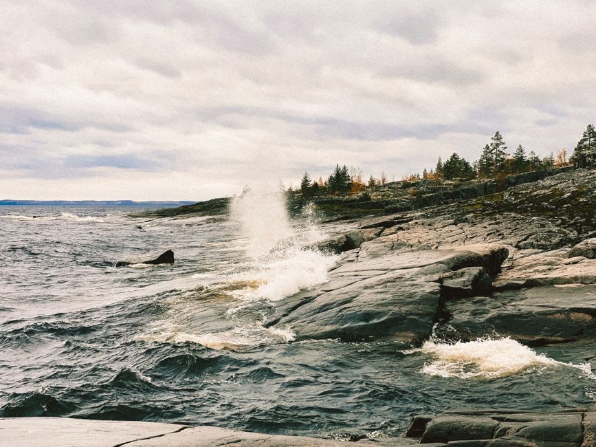 Lake Ladoga stretching toward the horizon beyond the monastery's stone quay