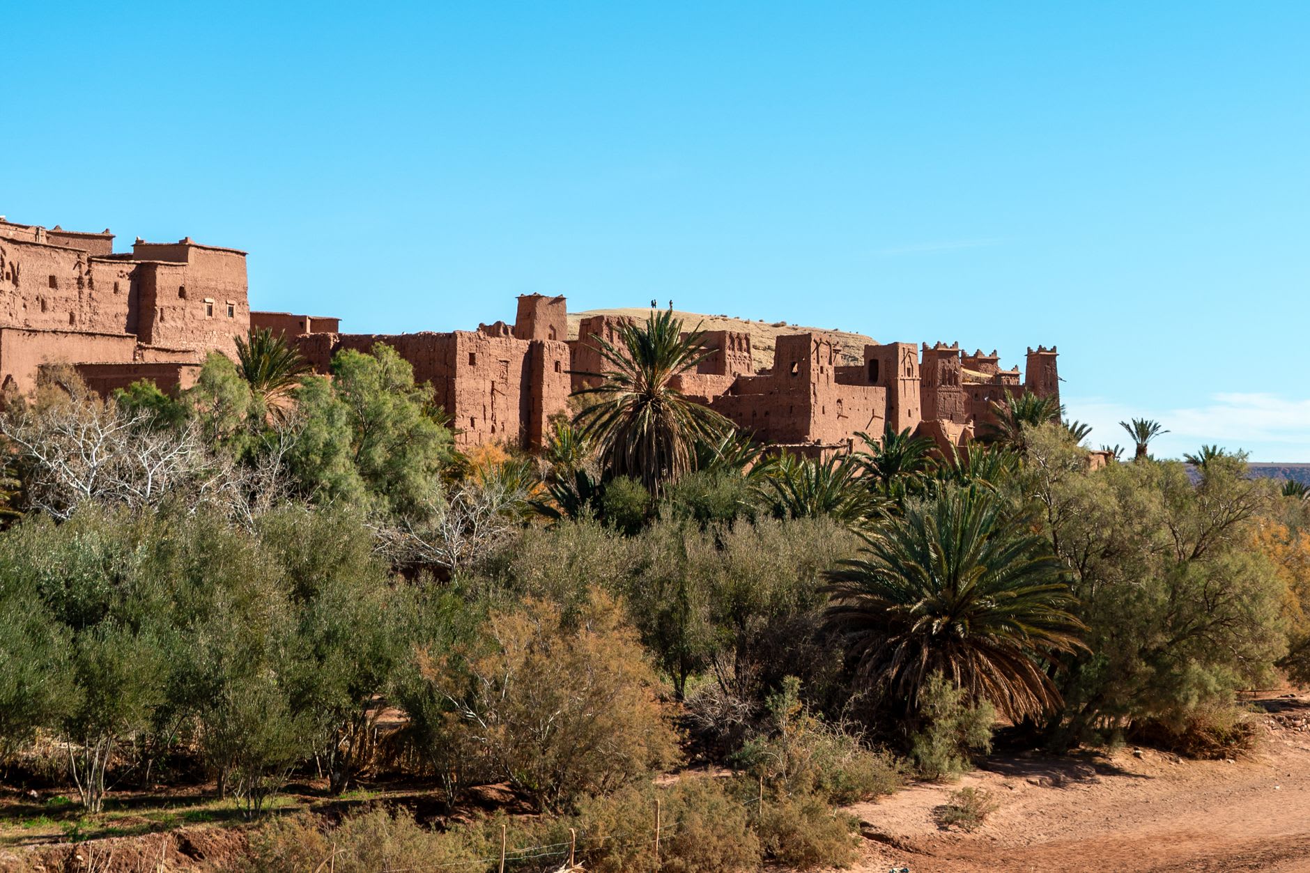 Interior courtyard of Kasbah Taourirt, carved plaster and zellige tilework in the warm Ouarzazate afternoon