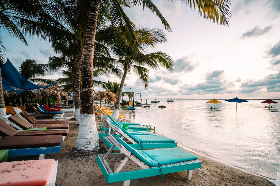 Beach bars and lounge chairs along the Caribbean side of Frigate Bay at sunset