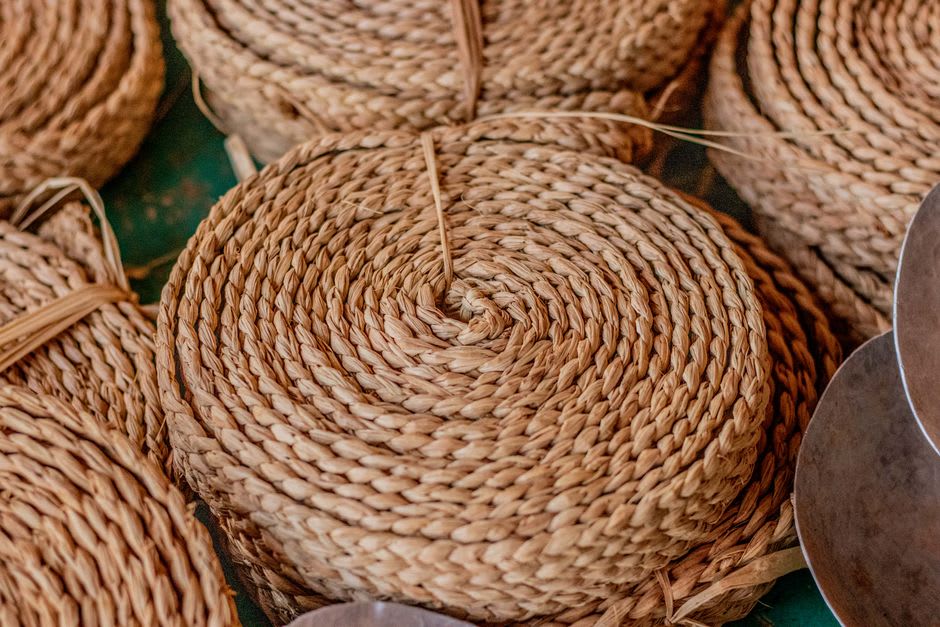 A woven basket and mat made from dried banana leaf displayed for sale in Choiseul