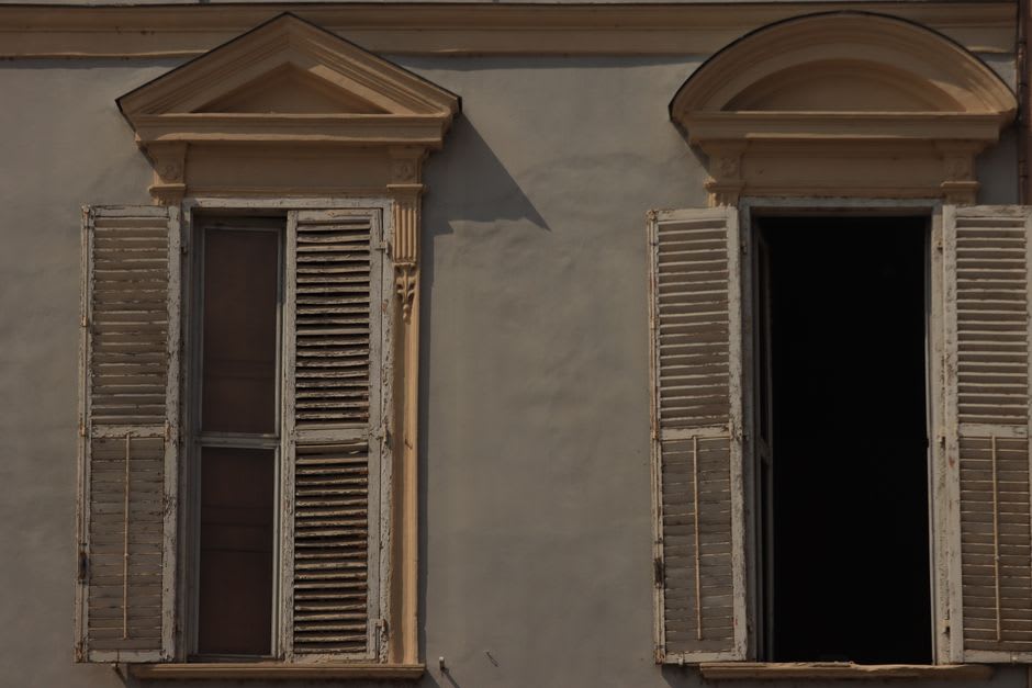Weathered wooden buildings from the sugar era lining Georgetown's quiet main road