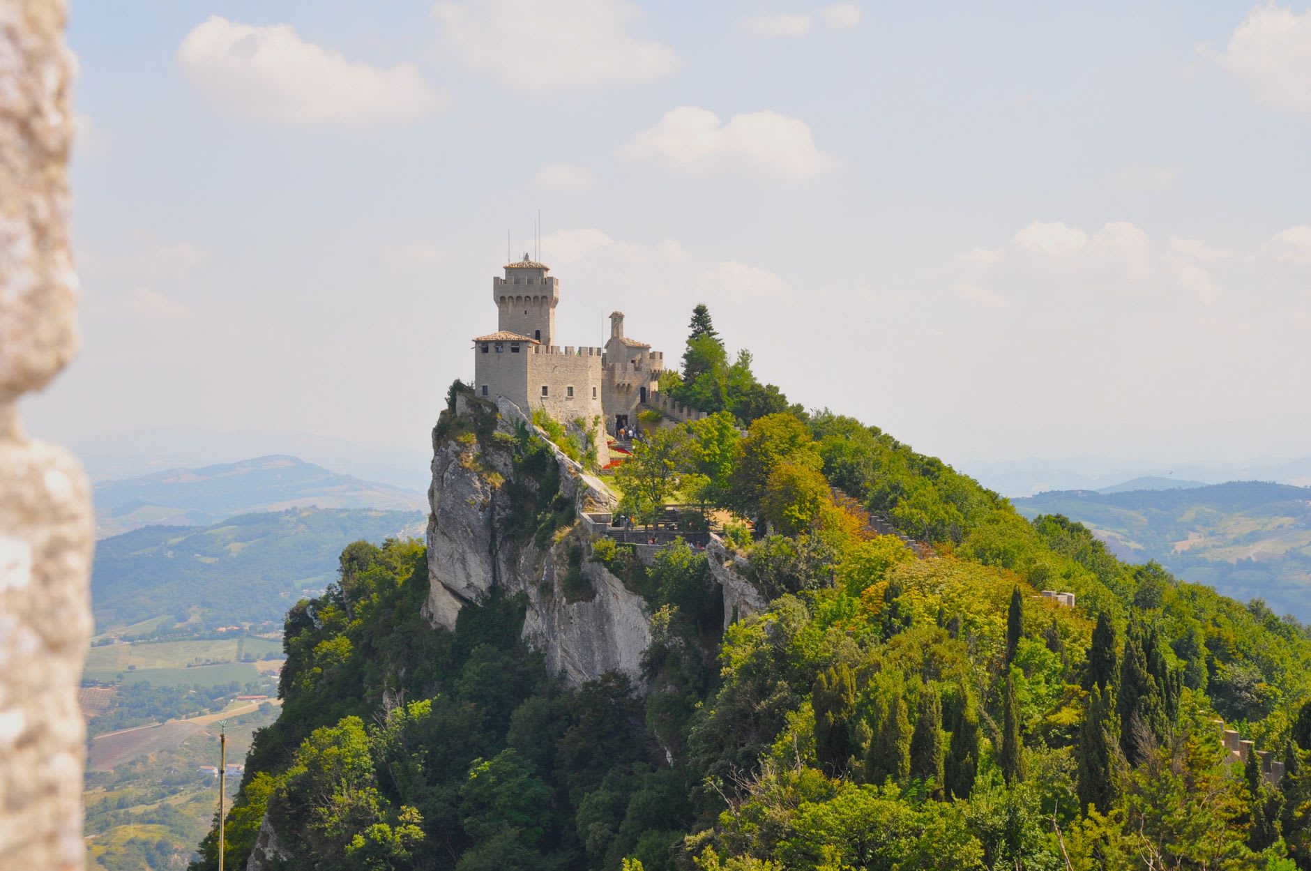 La Guaita's crenelated battlements against the morning sky, with the Romagna plain spreading far below