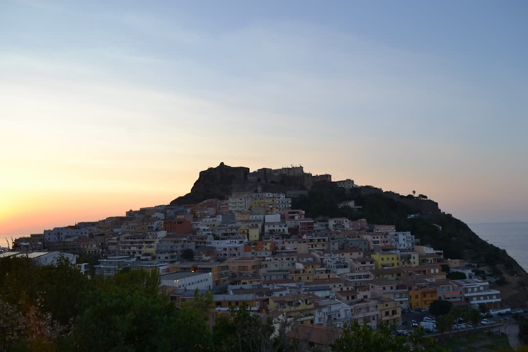 El Castello dei Doria y las casas pastel escalonadas de Castelsardo con vistas al mar al atardecer