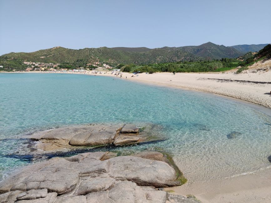The old Spanish watchtower at Porto Giunco standing between two facing turquoise bays