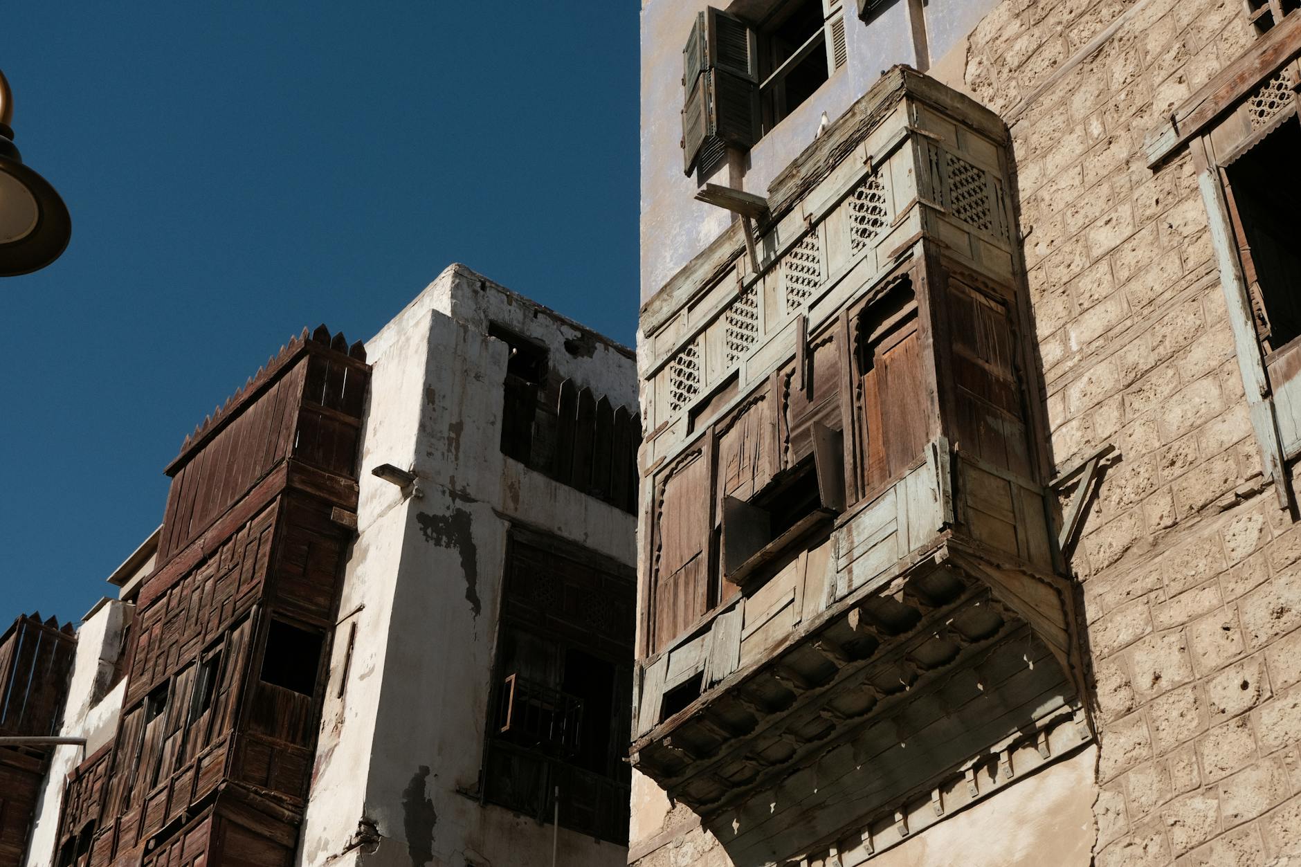 Ornate coral-stone tower houses with mashrabiya screens in Al Balad