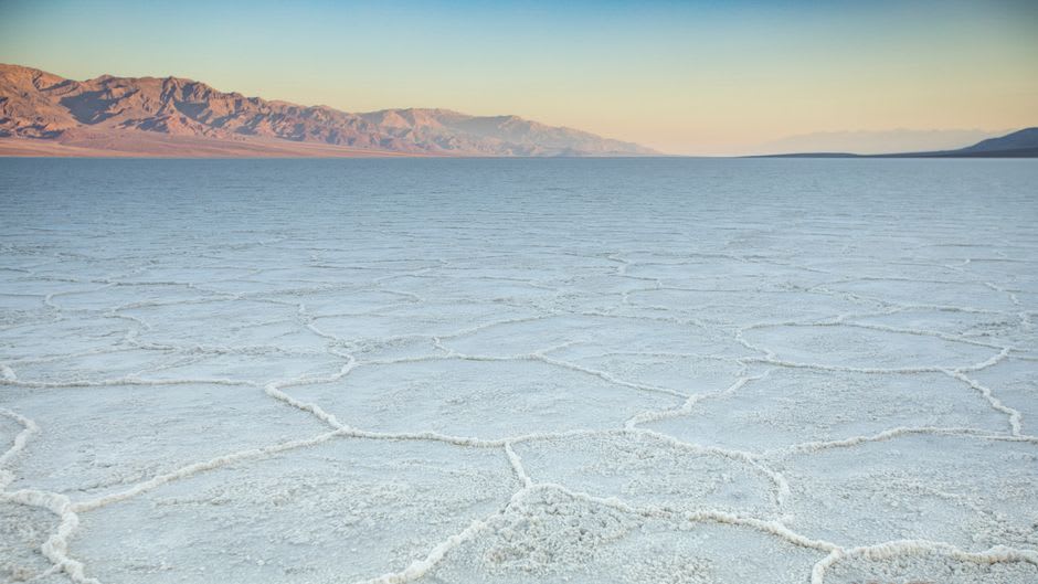 The dry basin of the former lake at Jubbah seen from the rock outcrop, surrounded by the Nefud desert