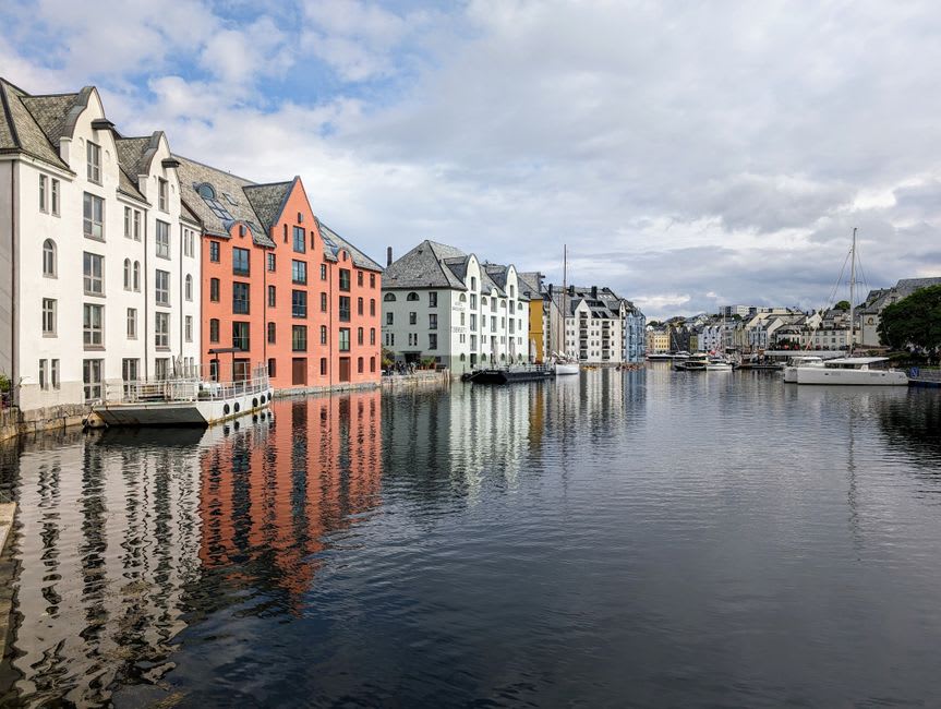 Colorful waterfront buildings reflected in the harbor water at Tobermory