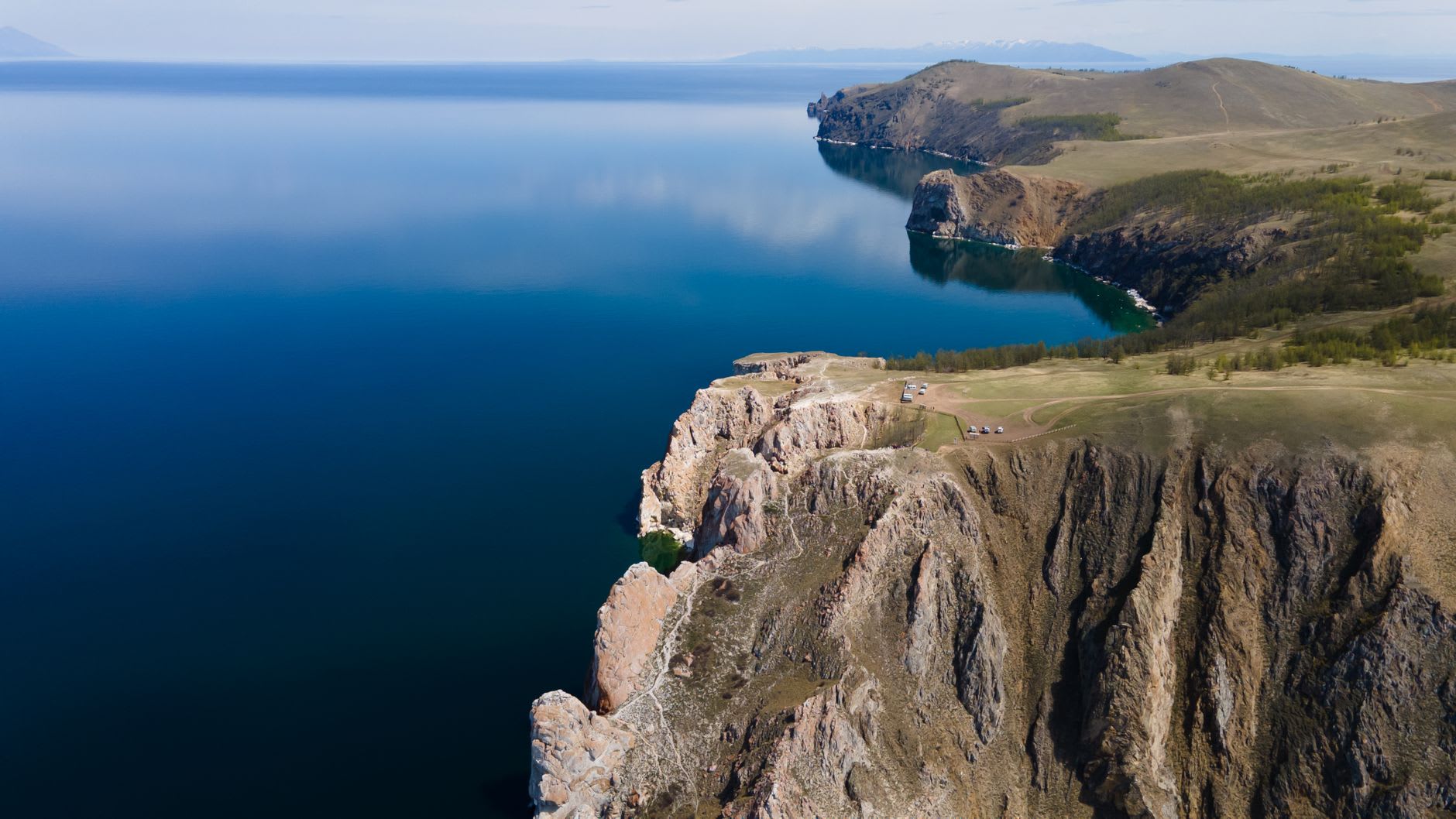 A nerpa seal sunning on Baikal's summer ice shelf, the lake's impossible blue water behind it