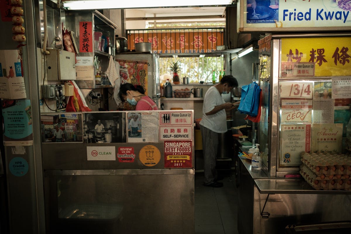 Steaming dishes and busy stalls at a traditional Singapore hawker centre