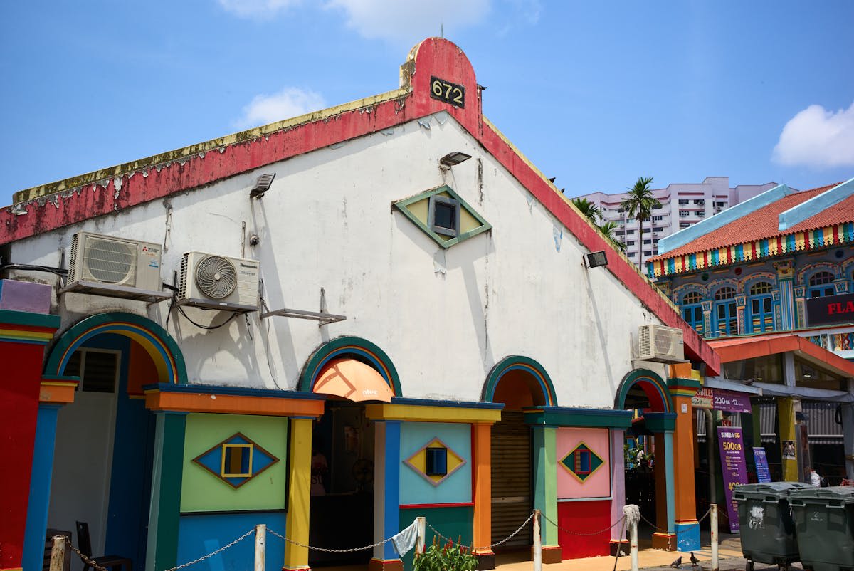 Vibrant flower garlands and spice displays at a Little India market stall
