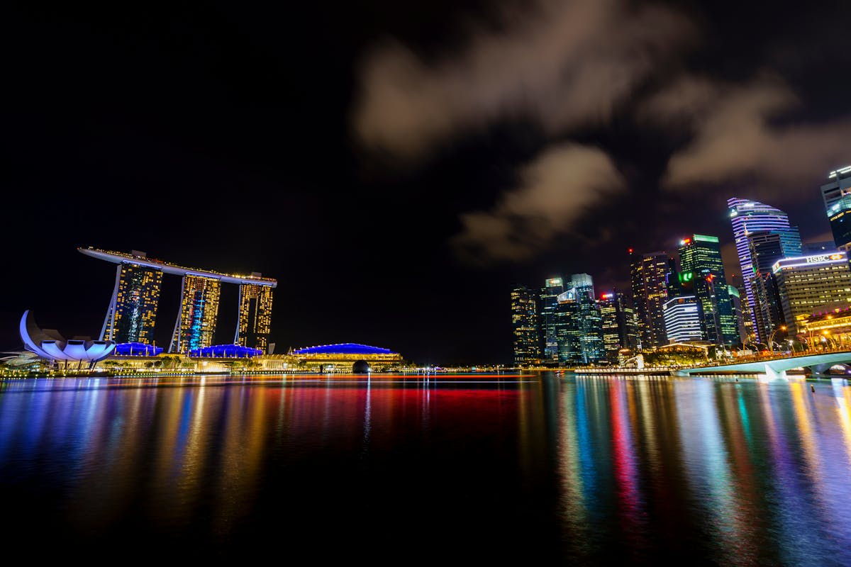 The Marina Bay Sands hotel and waterfront promenade illuminated at dusk