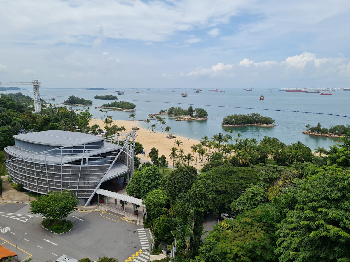 A tropical beach on Sentosa Island with palm trees and turquoise water