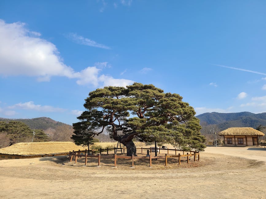 Traditional Korean village with thatched-roof houses along a river