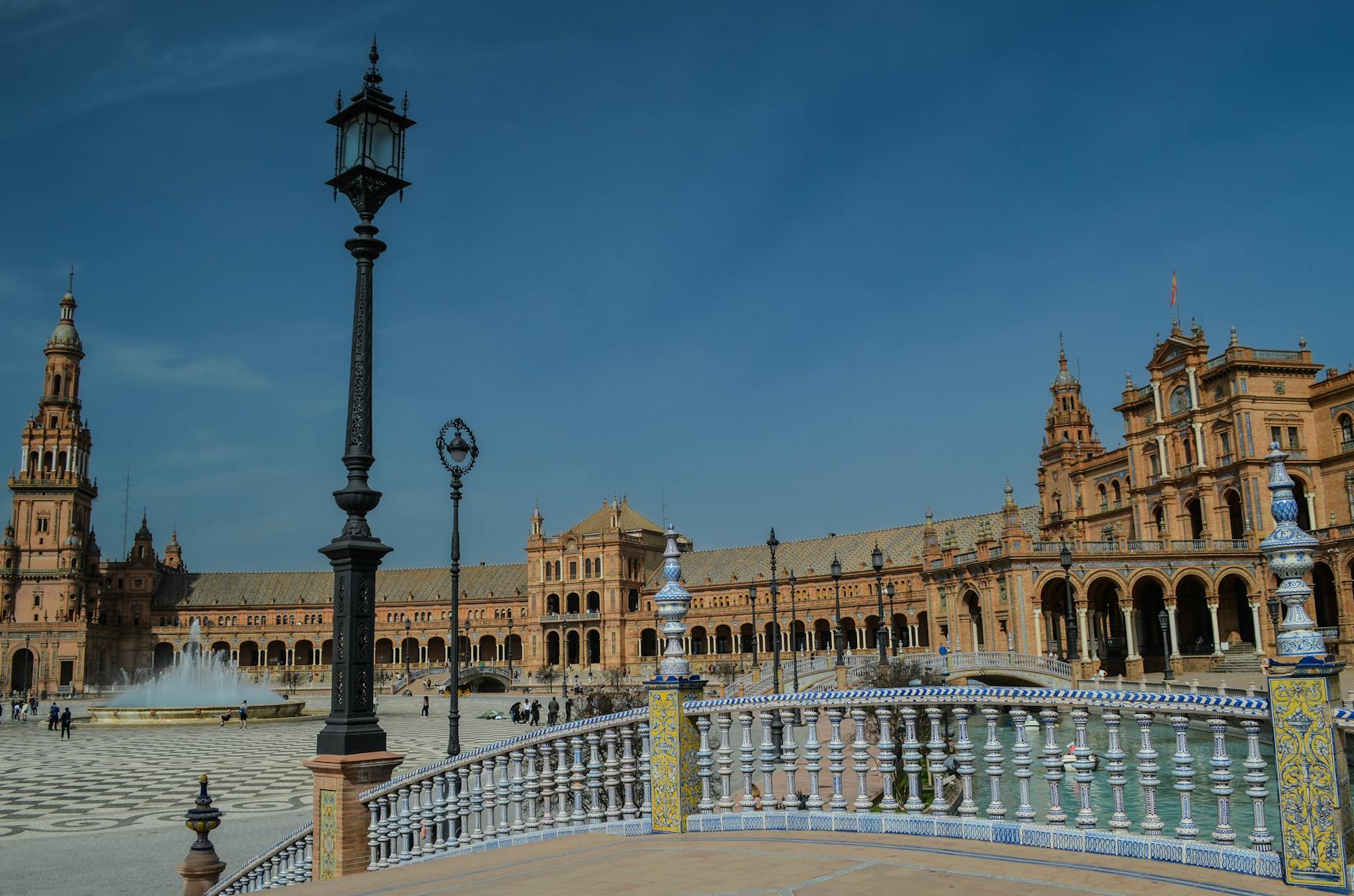 The grand tiled plaza and canal of Seville's Plaza de España in warm light