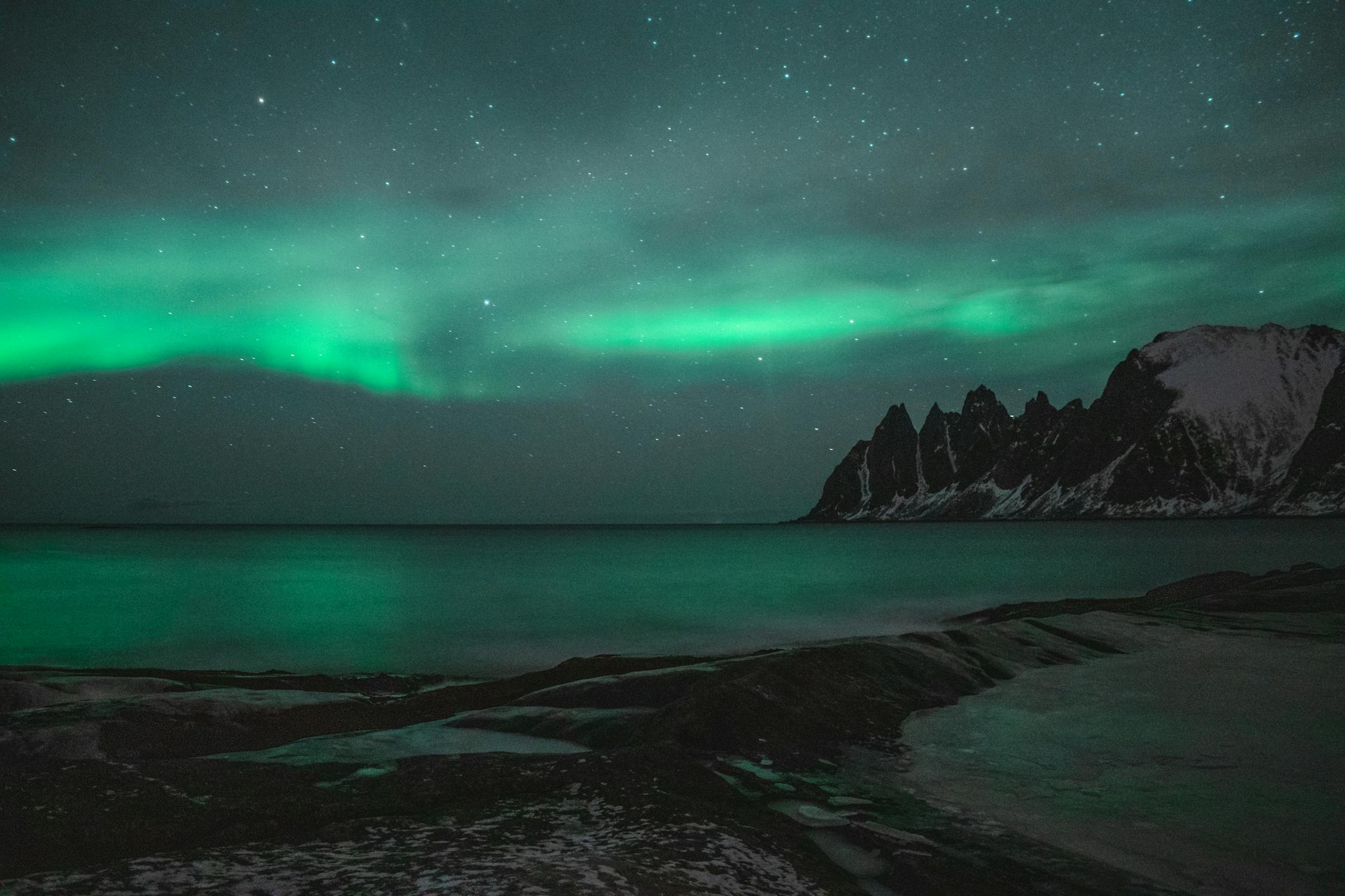 Northern lights dancing over a snow-covered Arctic landscape