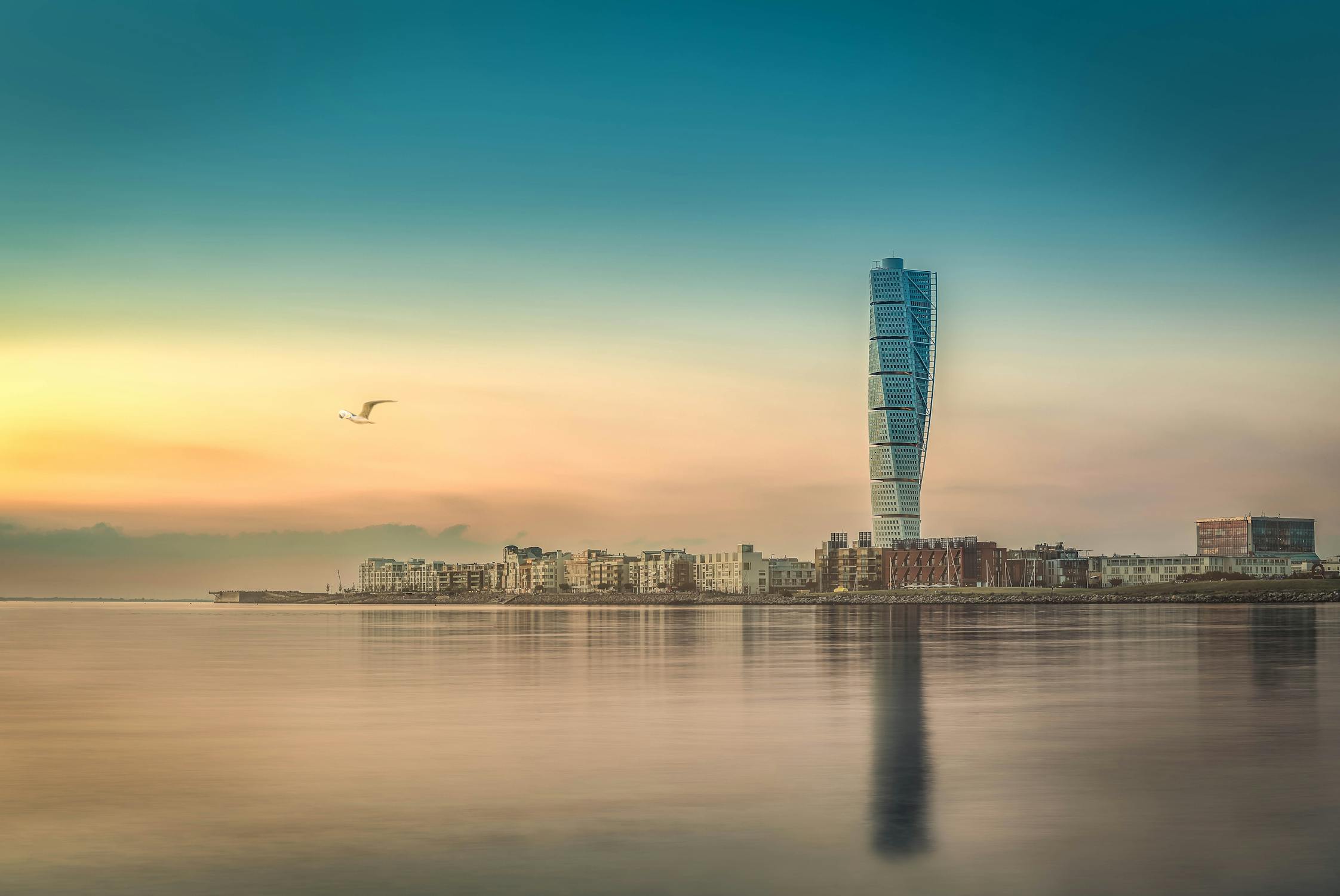 Malmo city skyline reflected in water at sunset