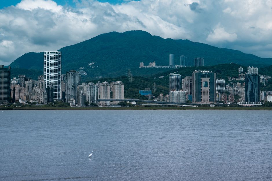 The red-brick Fort San Domingo with the wide mouth of the Danshui River and Guanyin Mountain visible in the distance