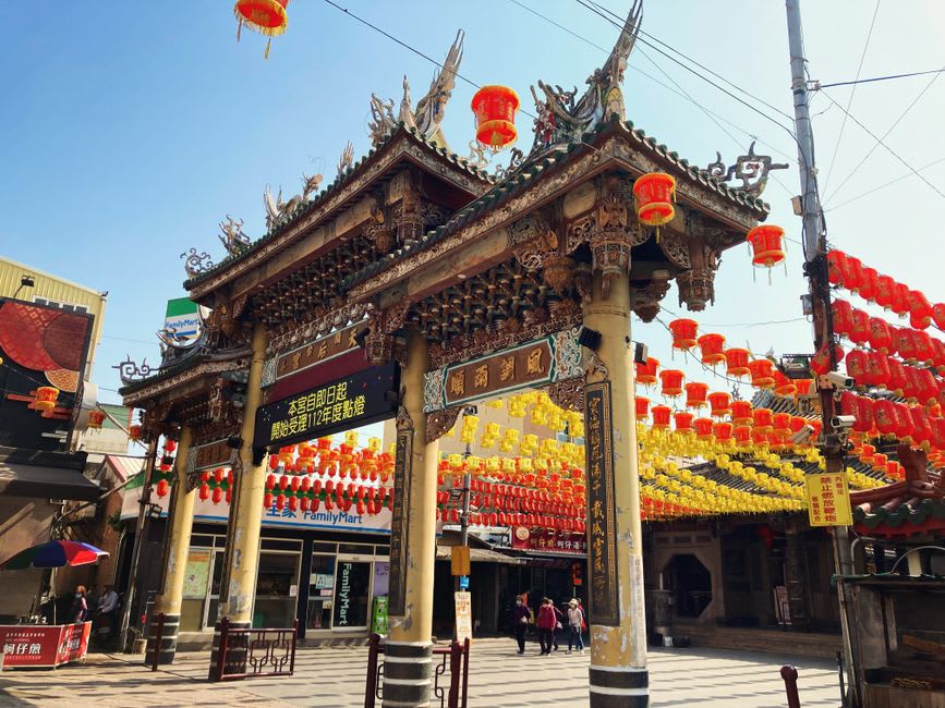 Weathered dark wooden roof beams and carved details inside the centuries-old Longshan Temple in Lukang