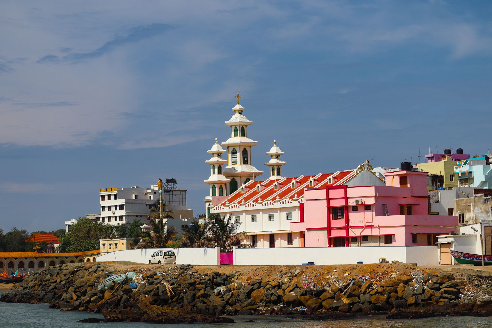 Waves from different directions colliding in a churned line of foam off the rocky southern point of Kanyakumari