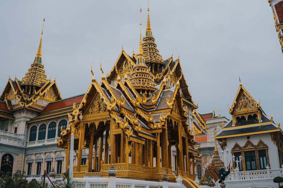 Boats on the Chao Phraya River with Bangkok temples in the background