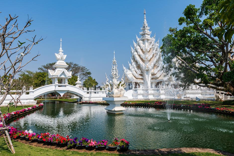 The intricate white facade of Wat Rong Khun gleaming in the morning light