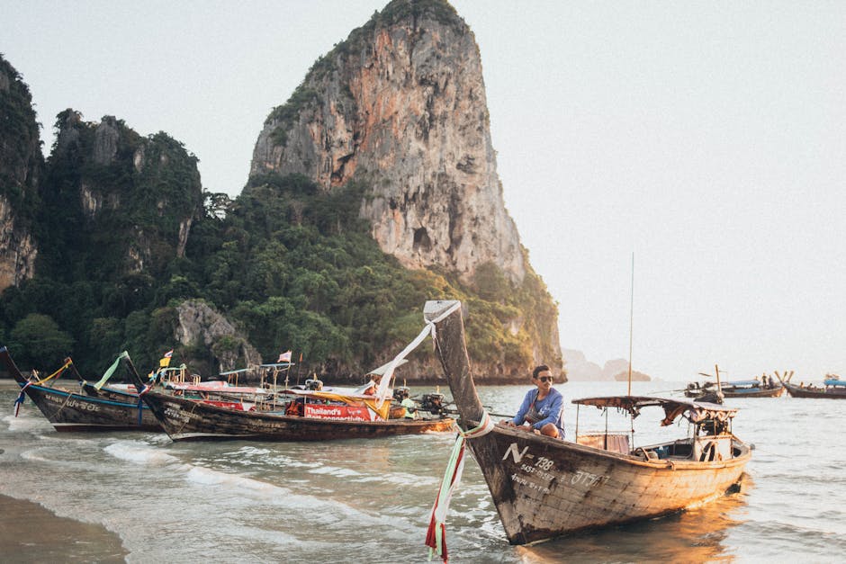 Longtail boats anchored in crystal waters off a Krabi island