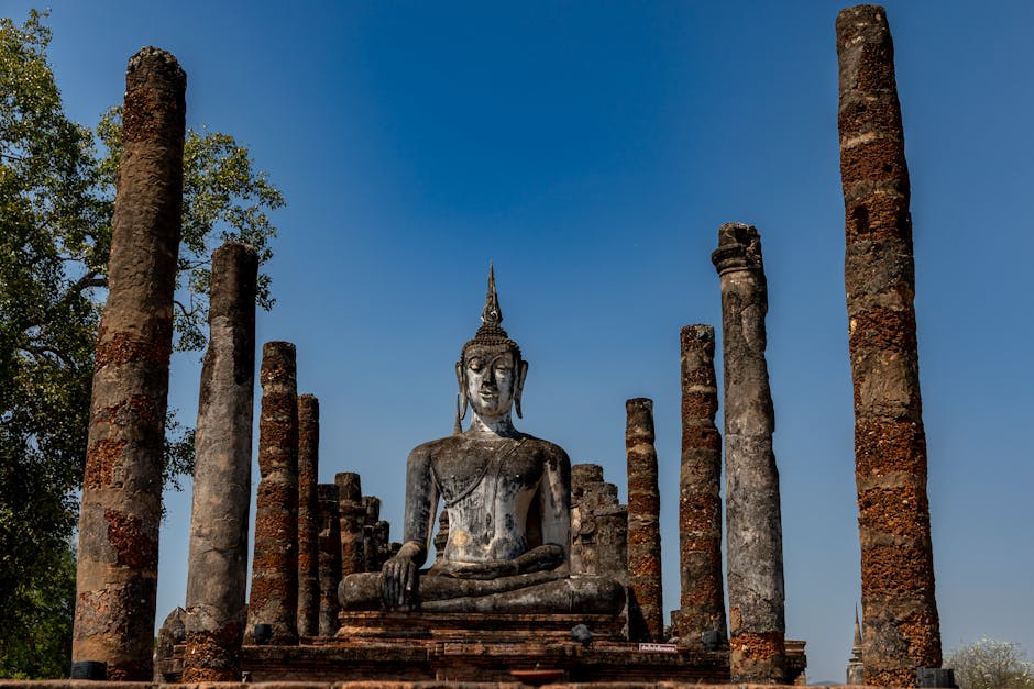 Ancient temple ruins surrounded by green parkland in Sukhothai's northern zone