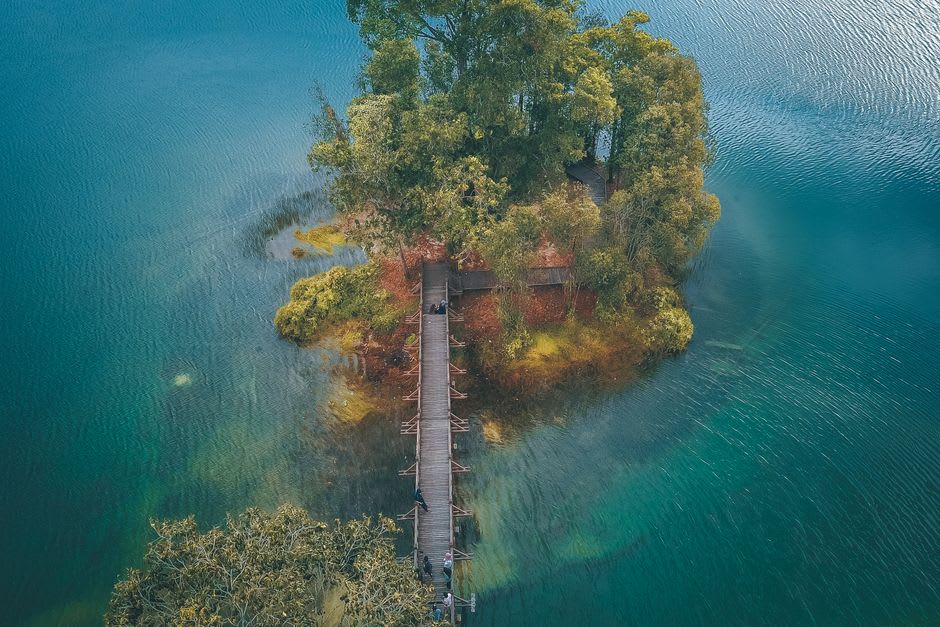 Wooden footbridge leading toward Tashi Island monastery on Basum Lake