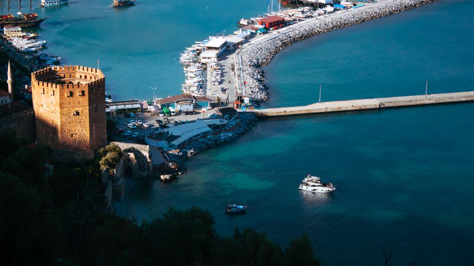 The Red Tower and old harbor of Alanya at sunset