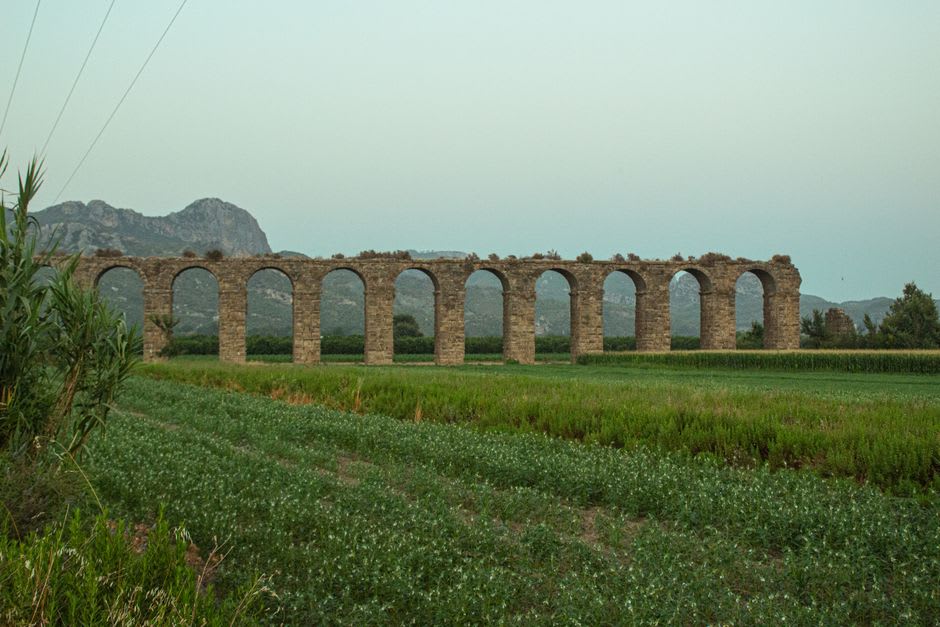 The ancient aqueduct arches of Aspendos striding across the countryside