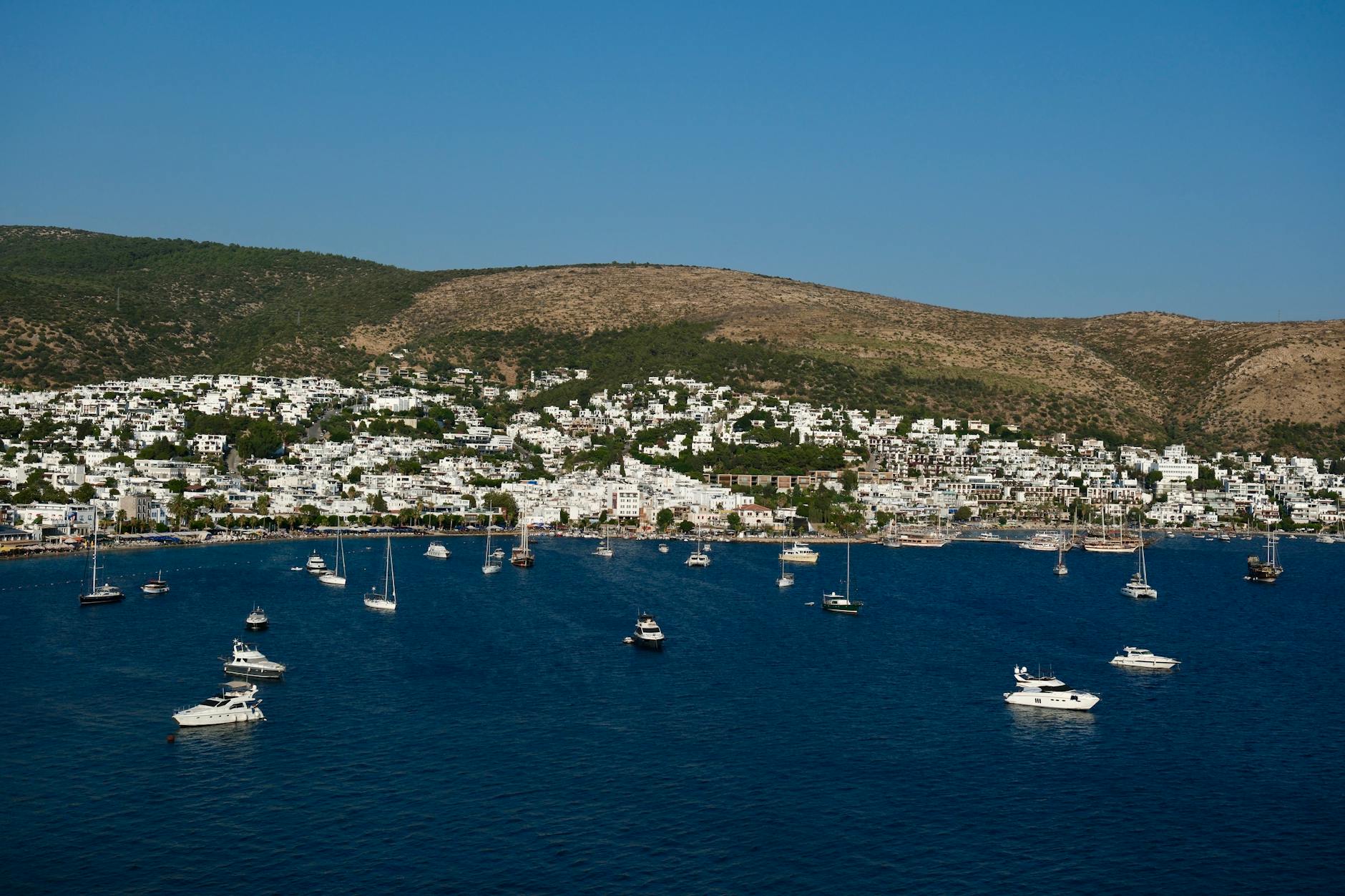 Boats anchored in the crystal-clear Aegean waters along the Bodrum coast