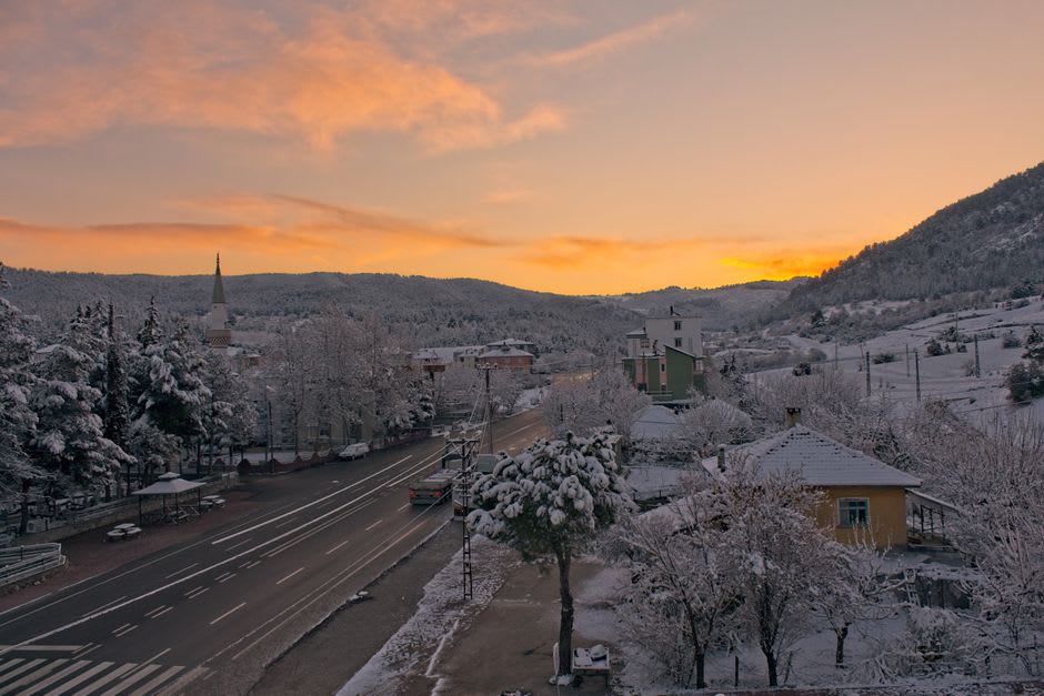 The main street of Bolu with mountains visible in the background at dusk