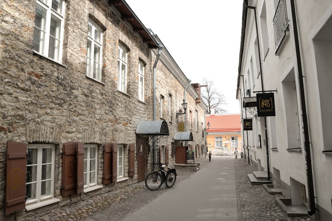 Narrow stone lanes in Bozcaada's old harbor village with the castle visible above