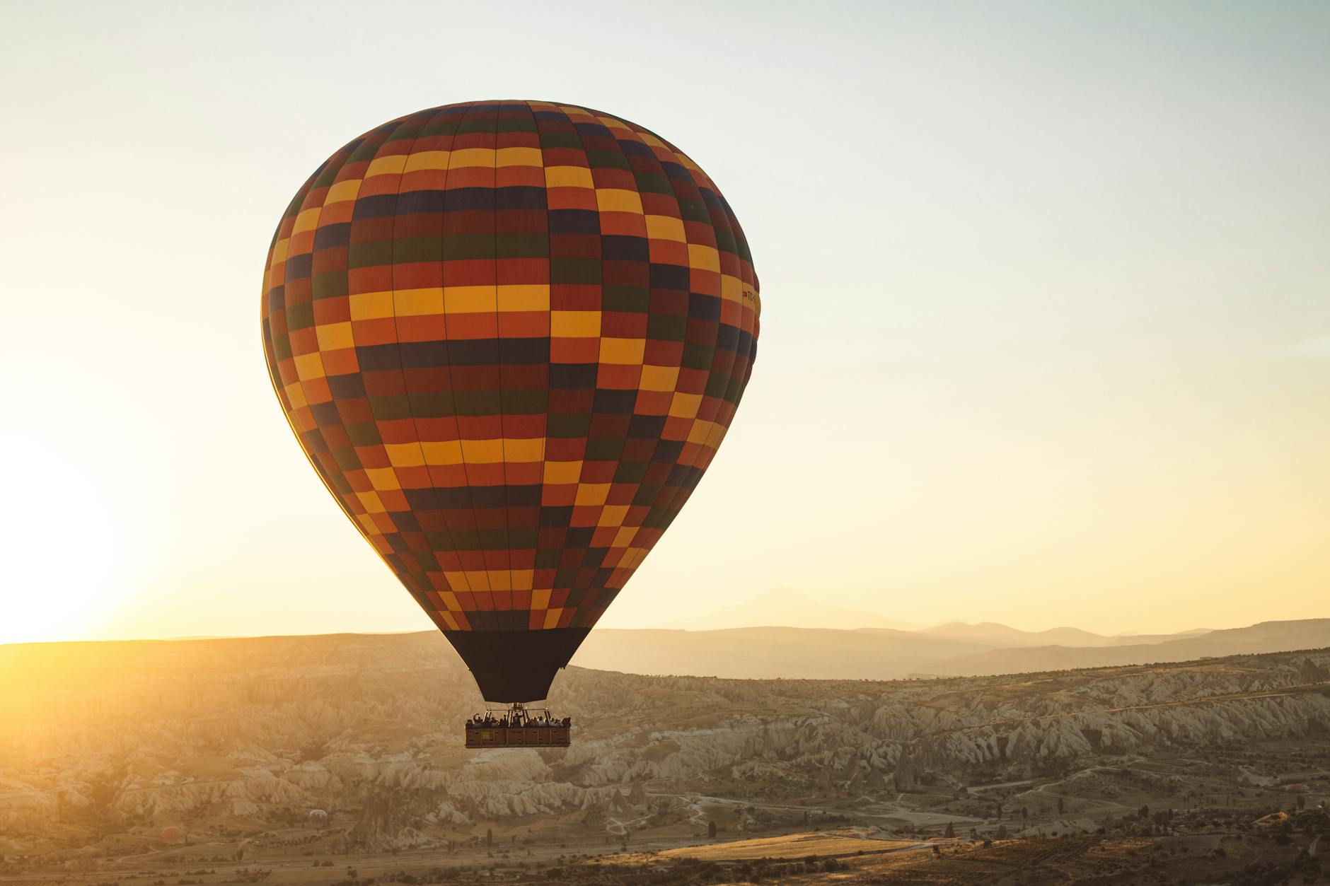Hot air balloons floating over Cappadocia's valleys at sunrise