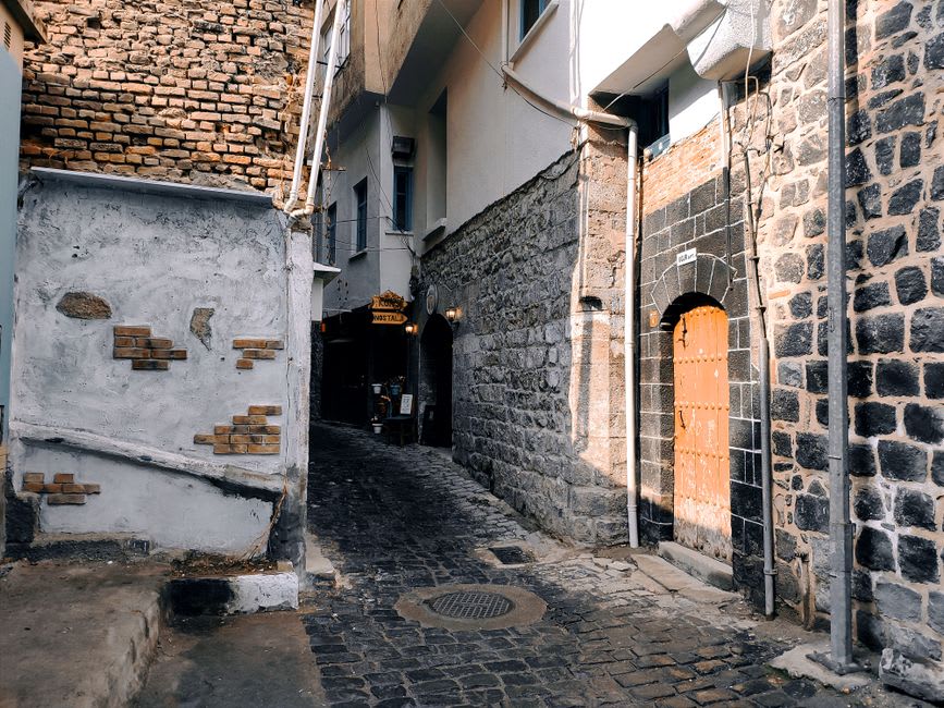 Traditional black basalt and white limestone banded houses in Diyarbakır's old city lanes